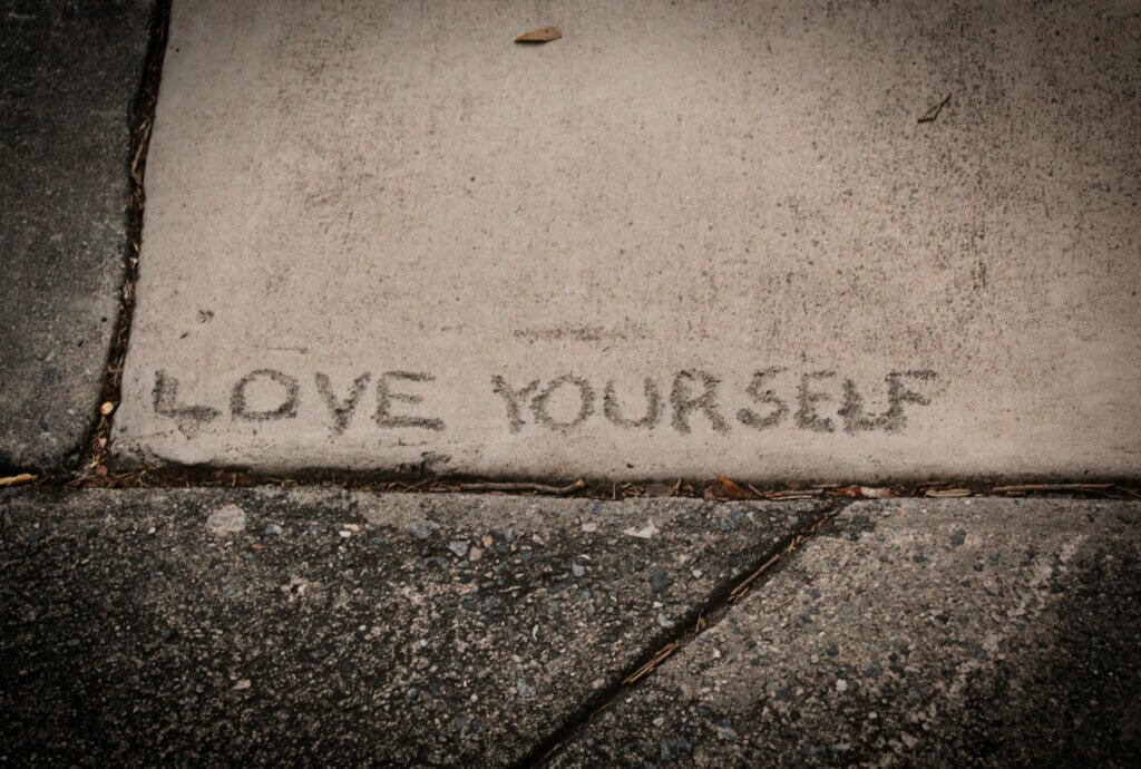 Love yourself written into concrete